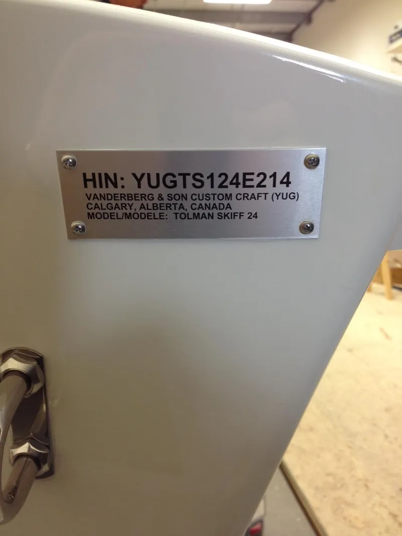 Slide: The Image of Metal plate on a 2014 Custom 24' Center Console boat, displaying HIN and model details. - 24