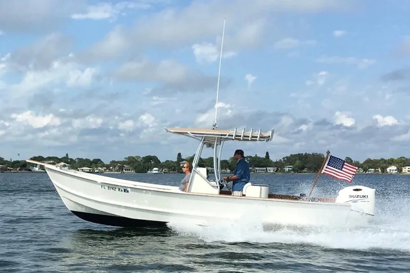 Slide: The Image of Custom 2014 24' Center Console boat cruising on water with American flag. - 25