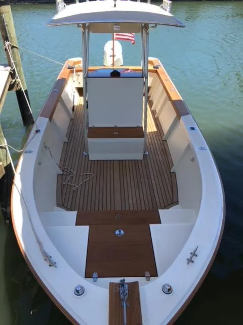Slide: The Image of Custom 2014 24' Center Console boat with wooden deck, docked in calm waters. - 26