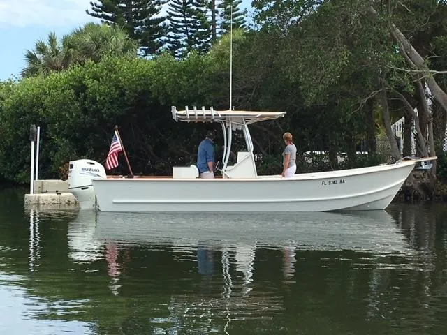 Slide: The Image of 2014 Custom 24' Center Console boat on calm water, with two people onboard. - 8