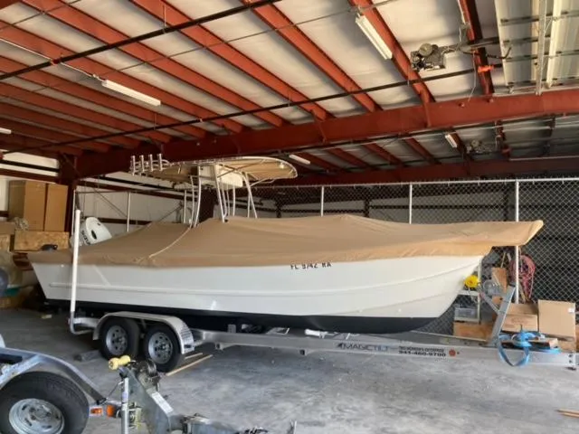 Slide: The Image of 2014 Custom 24' Center Console boat on trailer in storage facility. - 9