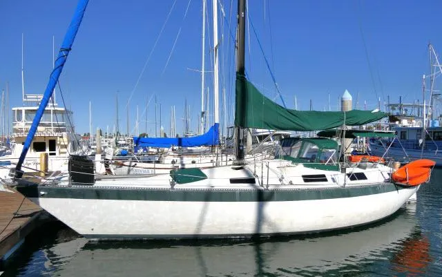 Slide: The Image of 1976 Choate Custom 38 sailboat docked in a marina under clear blue skies. - 1