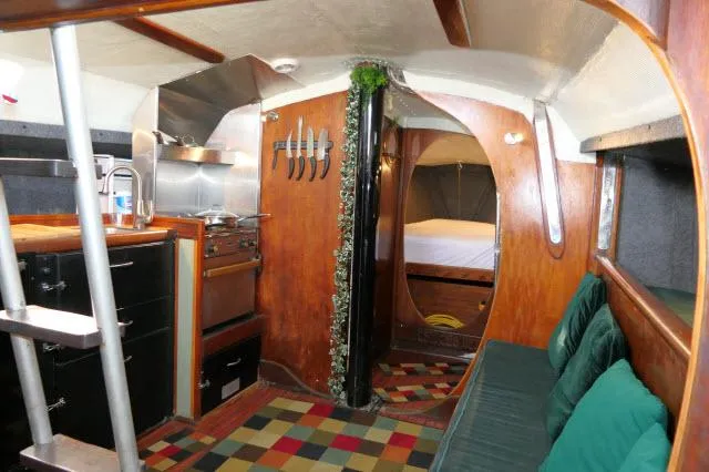 Slide: The Image of Interior of 1976 Choate Custom 38 sailboat with cozy kitchen and seating area. - 12