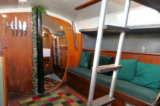 Slide: The Image of Interior of 1976 Choate Custom 38 sailboat with cozy seating and colorful decor. - 13