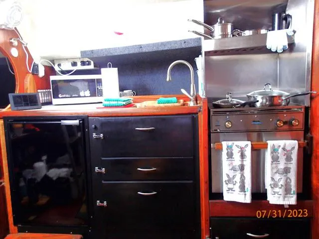 Slide: The Image of 1976 Choate Custom 38 yacht kitchen with stove, sink, and storage cabinets. - 16