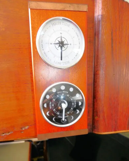 Slide: The Image of Tide and moon phase gauges on 1976 Choate Custom 38 wooden panel. - 22