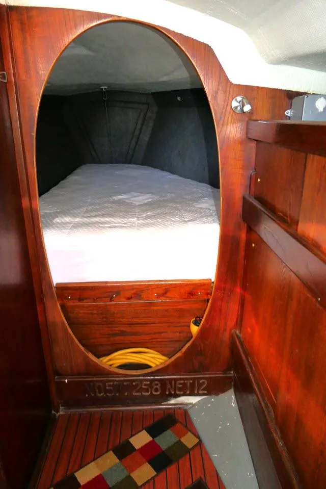Slide: The Image of Interior of 1976 Choate Custom 38 sailboat with wooden finish and cozy sleeping area. - 23