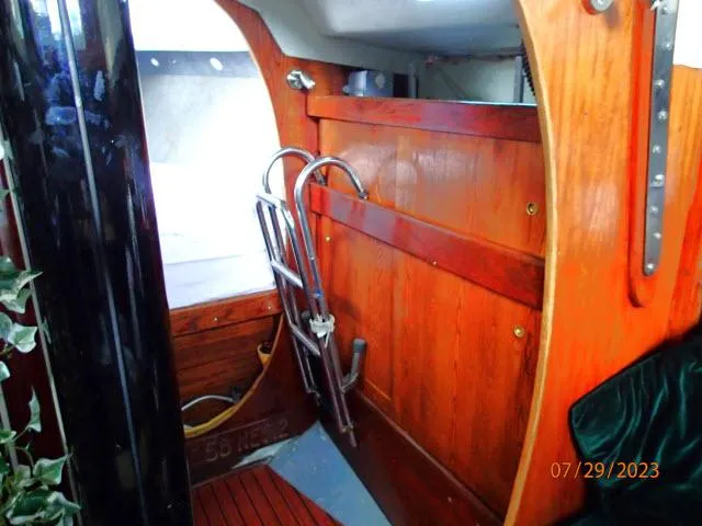 Slide: The Image of Interior of 1976 Choate Custom 38 sailboat with wooden paneling and metal ladder. - 26