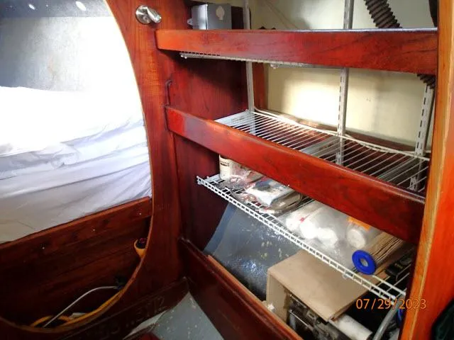 Slide: The Image of Interior of 1976 Choate Custom 38 with wooden shelves and storage area. - 28