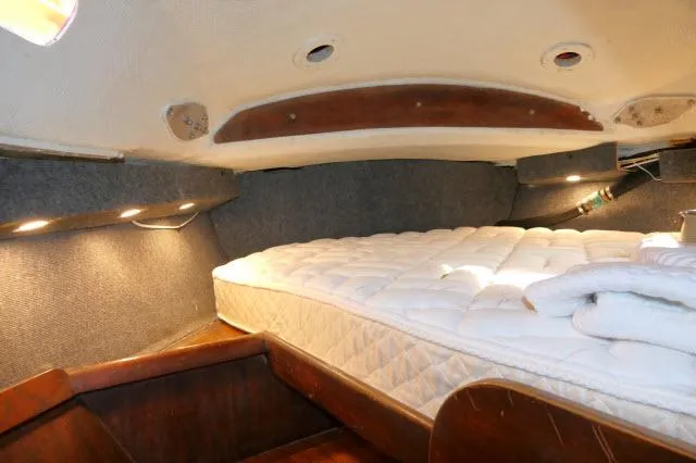 Slide: The Image of Interior cabin of 1976 Choate Custom 38 sailboat with cozy bedding and wood accents. - 31