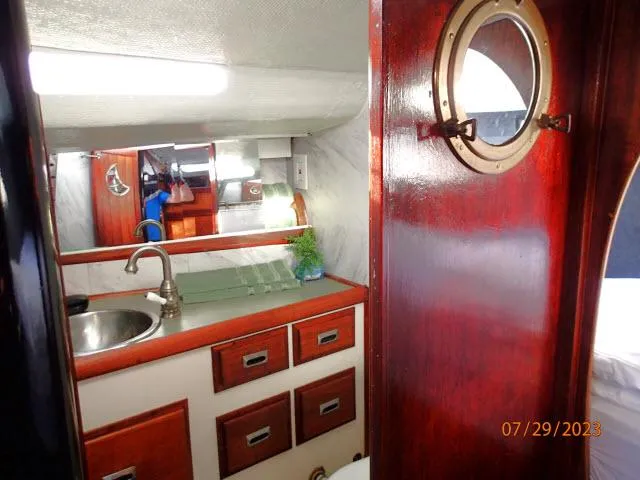 Slide: The Image of 1976 Choate Custom 38 yacht interior with wooden cabinetry and porthole. - 32