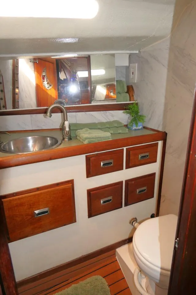 Slide: The Image of 1976 Choate Custom 38 yacht bathroom with wooden cabinets and stainless steel sink. - 33