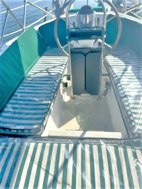 Slide: The Image of 1976 Choate Custom 38 sailboat cockpit with striped seating and steering wheel. - 34