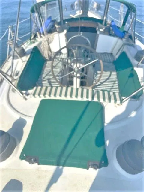 Slide: The Image of 1976 Choate Custom 38 sailboat cockpit with green seating and steering wheel. - 35