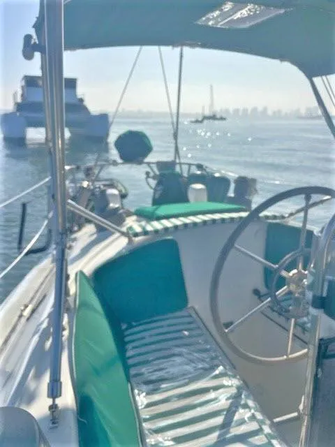 Slide: The Image of 1976 Choate Custom 38 sailboat with green seating, docked in sunny marina. - 37