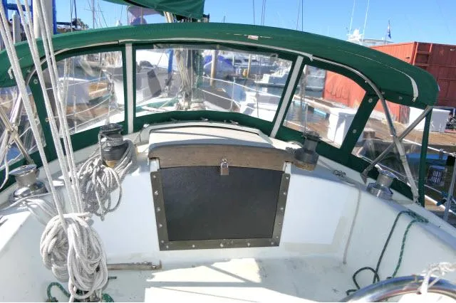 Slide: The Image of 1976 Choate Custom 38 sailboat cockpit with green canopy and ropes. - 40