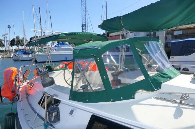 Slide: The Image of 1976 Choate Custom 38 sailboat with green canopy docked at marina. - 41