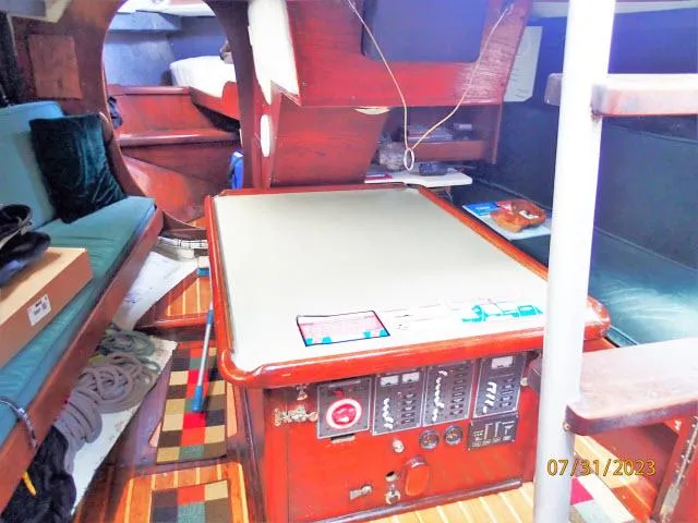 Slide: The Image of Interior of 1976 Choate Custom 38 sailboat with wooden furnishings and navigation equipment. - 48