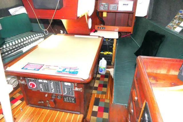 Slide: The Image of Interior of 1976 Choate Custom 38 sailboat with navigation station and seating area. - 7