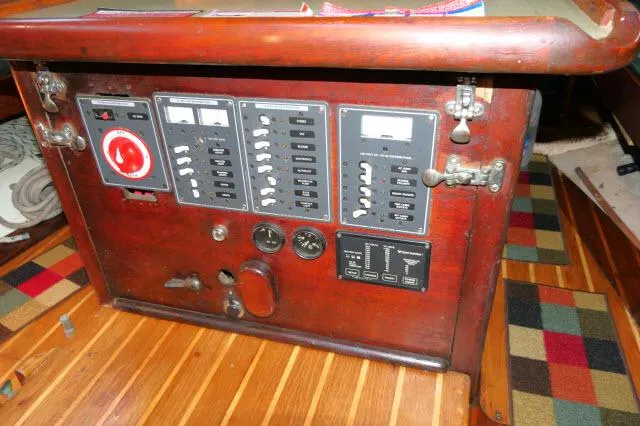 Slide: The Image of Control panel of 1976 Choate Custom 38 sailboat with wooden finish and switches. - 9