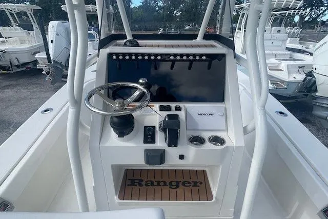 Slide: The Image of 2024 Ranger 2600 Bay boat console with steering wheel and Mercury controls. - 3