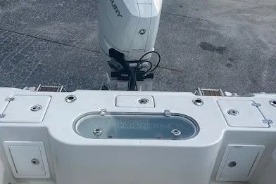 Slide: The Image of 2024 Ranger 2600 Bay boat with Mercury engine, featuring a spacious deck and storage compartments. - 4