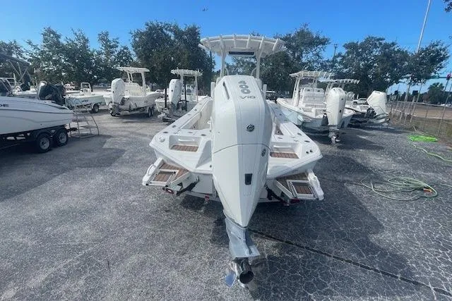 Slide: The Image of 2024 Ranger 2600 Bay boat in a marina, surrounded by other boats. - 5