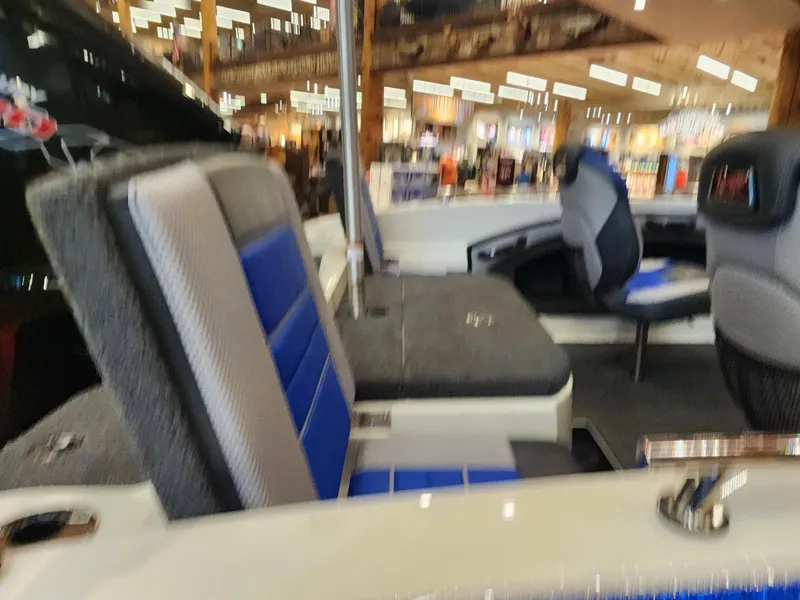 Slide: The Image of 2024 Ranger 1880MS boat interior with blue and gray seating. - 5