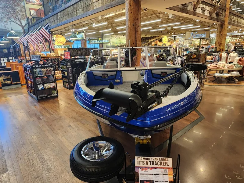 Slide: The Image of 2024 Ranger 1880MS boat on display in a store with accessories. - 6