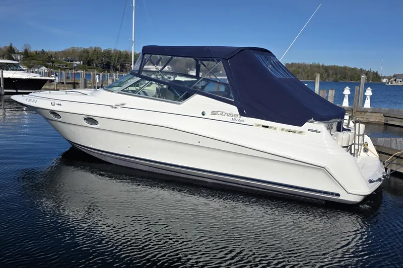 The Image of 1997 Cruisers Yachts 3120 Aria docked in a serene marina setting. - 0