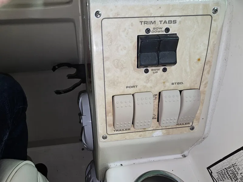 Slide: The Image of Trim tab controls on a 1997 Cruisers Yachts 3120 Aria boat. - 14