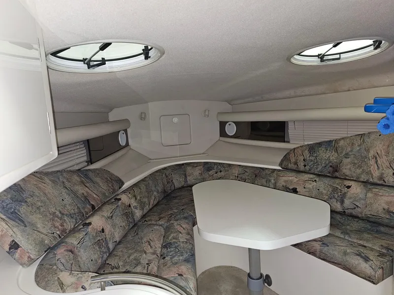 Slide: The Image of Interior of 1997 Cruisers Yachts 3120 Aria with seating and table. - 25