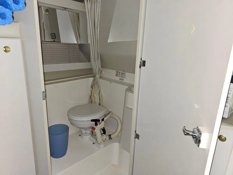 Slide: The Image of 1997 Cruisers Yachts 3120 Aria bathroom with toilet and curtain. - 26