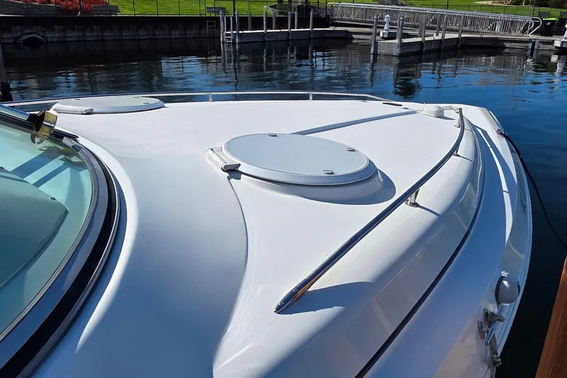 Slide: The Image of 1997 Cruisers Yachts 3120 Aria boat docked, showcasing sleek deck design. - 38
