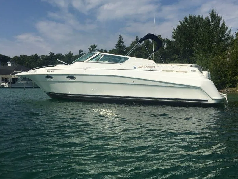 Slide: The Image of 1997 Cruisers Yachts 3120 Aria anchored on calm water. - 5