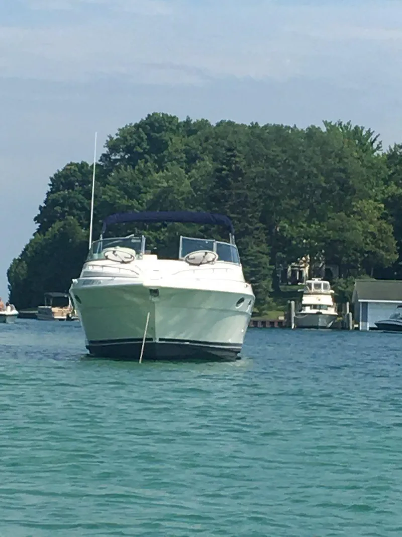 Slide: The Image of 1997 Cruisers Yachts 3120 Aria anchored on calm water. - 6