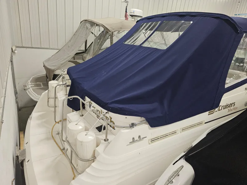 Slide: The Image of 1997 Cruisers Yachts 3120 Aria with blue cover in storage. - 7