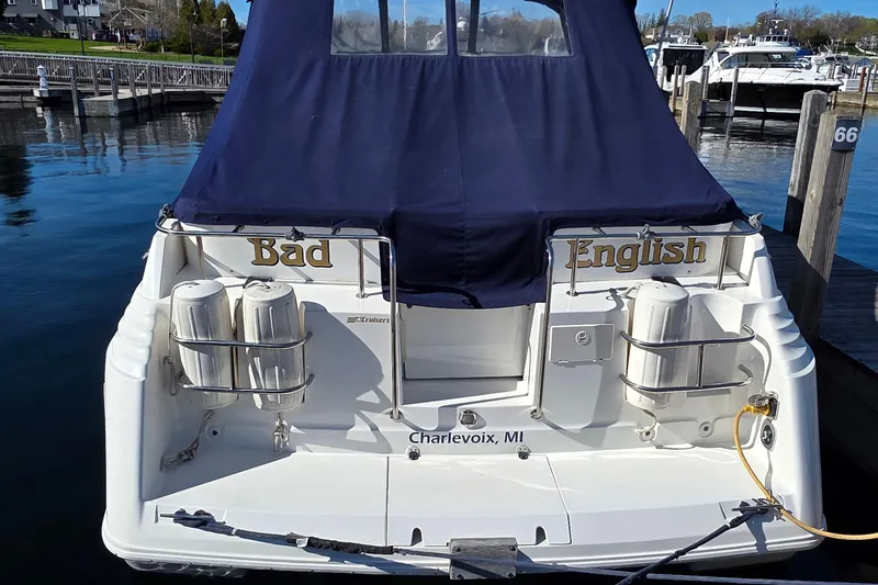 Slide: The Image of 1997 Cruisers Yachts 3120 Aria docked in Charlevoix, MI with navy cover. - 8