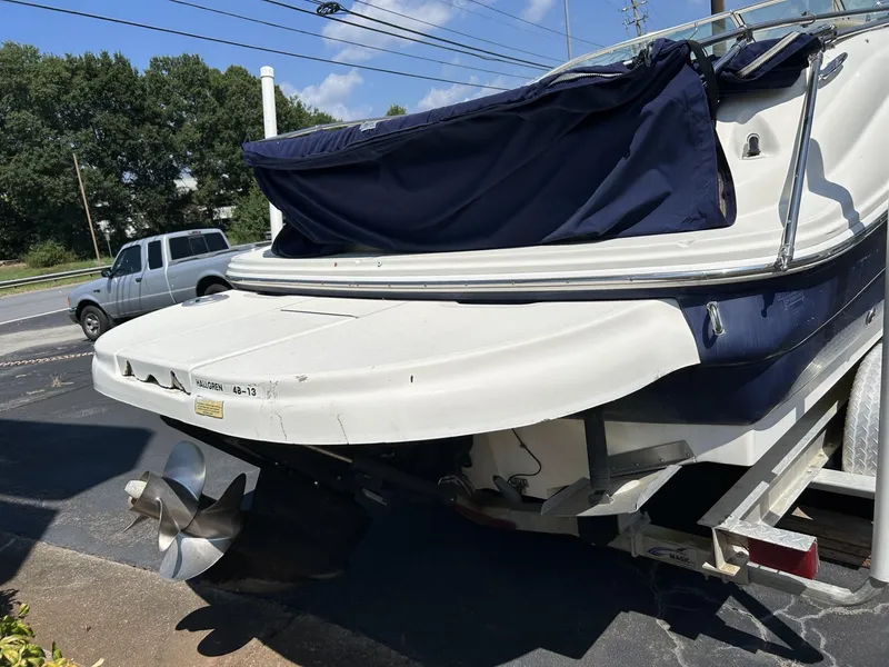 Slide: The Image of 2005 Sea Ray 240 SD boat on trailer, rear view with propeller visible. - 4