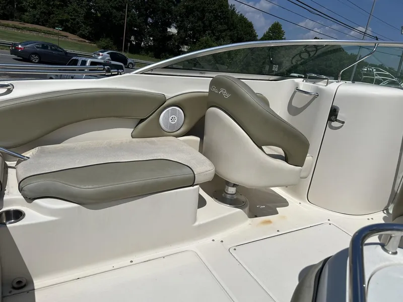 Slide: The Image of 2005 Sea Ray 240 SD boat interior with beige seating and speaker. - 5
