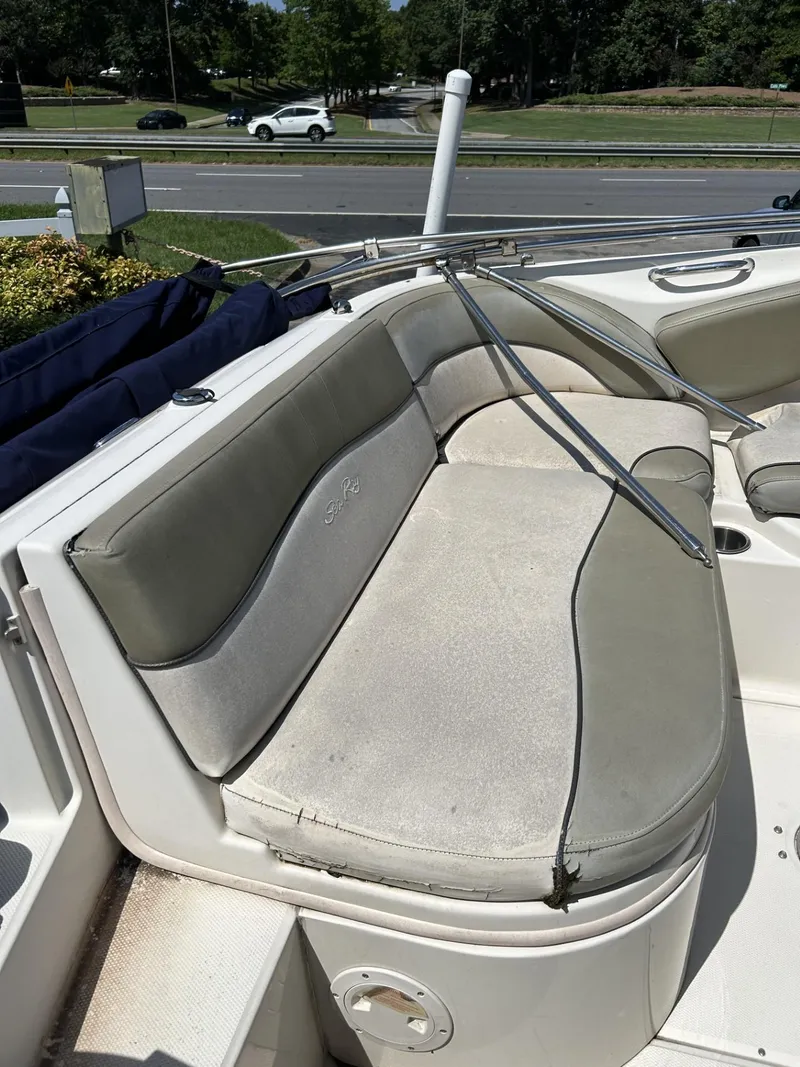 Slide: The Image of 2005 Sea Ray 240 SD boat with cushioned seating in outdoor setting. - 9