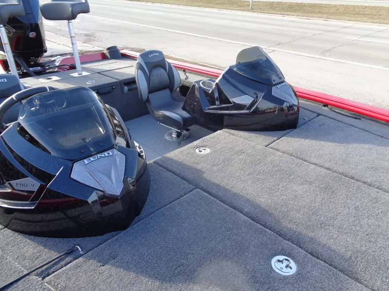 Slide: The Image of 2024 Lund 1875 Pro-V Bass boat interior with seating and console. - 10