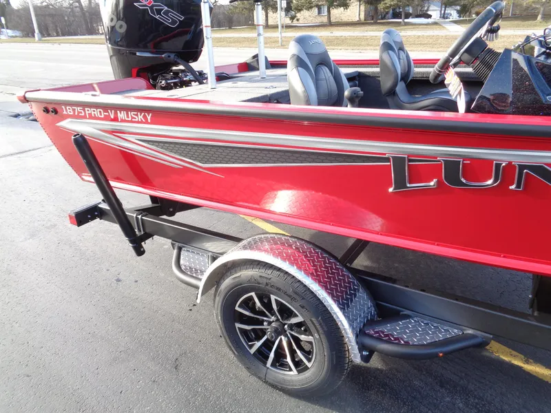 Slide: The Image of 2024 Lund 1875 Pro-V Bass boat in red on a trailer. - 11