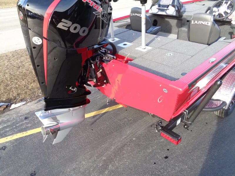 Slide: The Image of 2024 Lund 1875 Pro-V Bass boat with a 200 HP motor, rear view. - 4