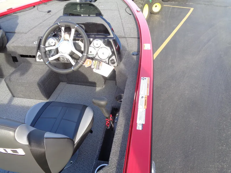 Slide: The Image of 2024 Lund 1875 Pro-V Bass boat interior with steering wheel and dashboard. - 5