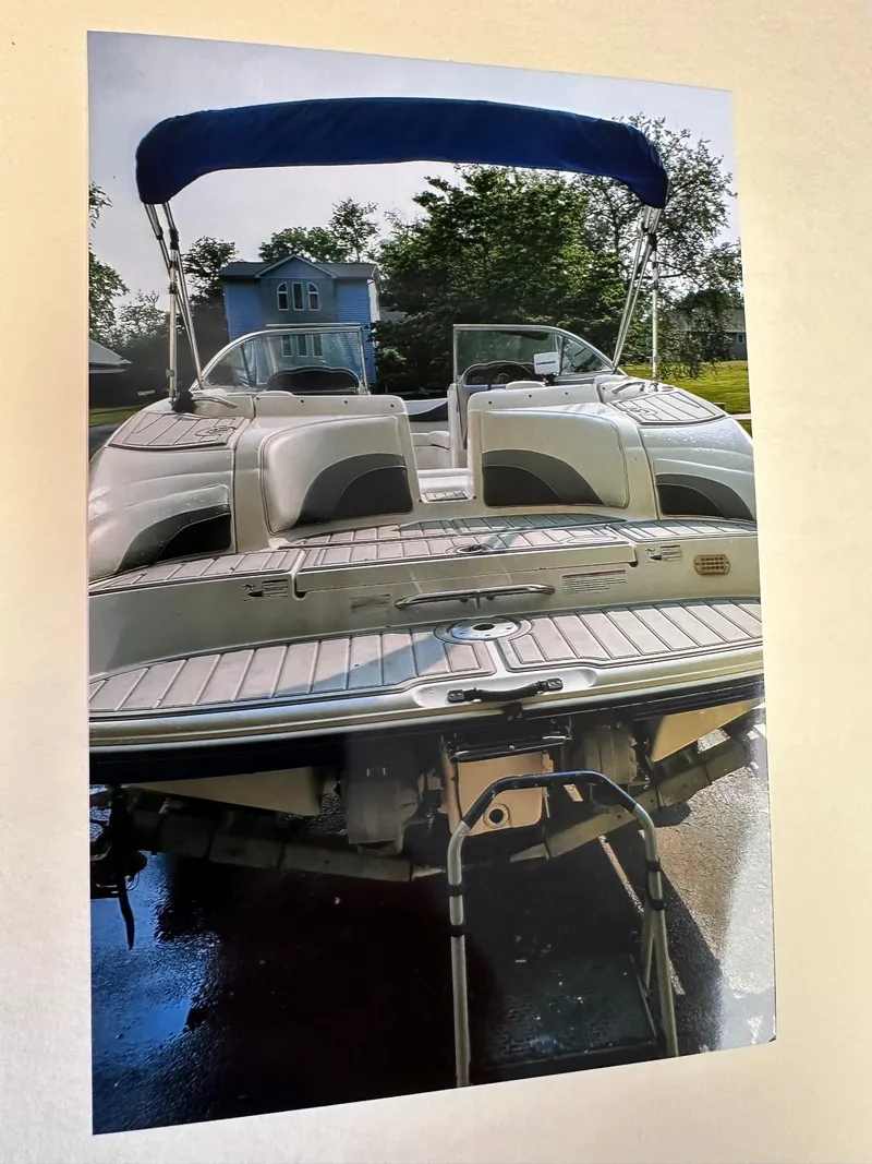 Slide: The Image of 2006 Yamaha Boats SX 230 with blue canopy and rear deck view. - 12