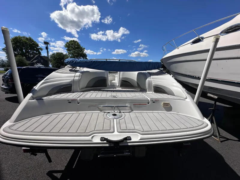 Slide: The Image of 2006 Yamaha Boats SX 230, rear view, docked under a clear blue sky. - 16