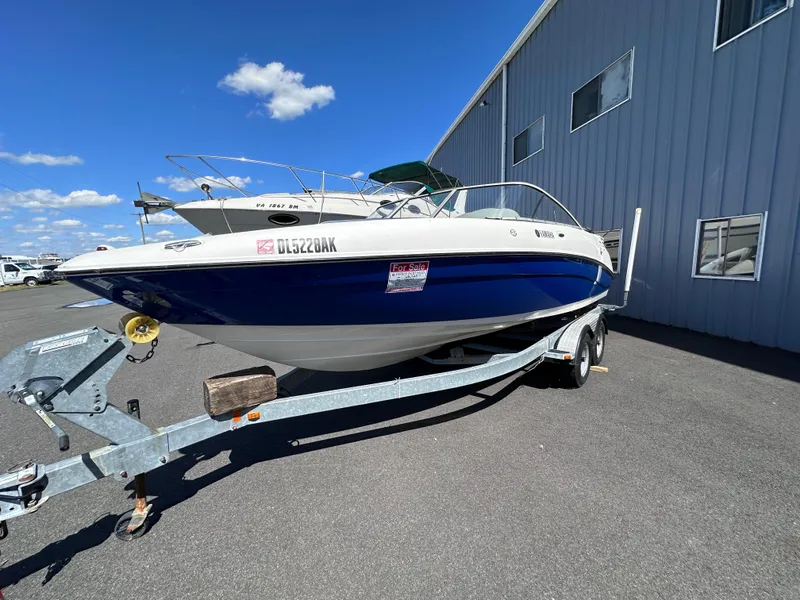Slide: The Image of 2006 Yamaha Boats SX 230 on trailer outside a warehouse. - 2