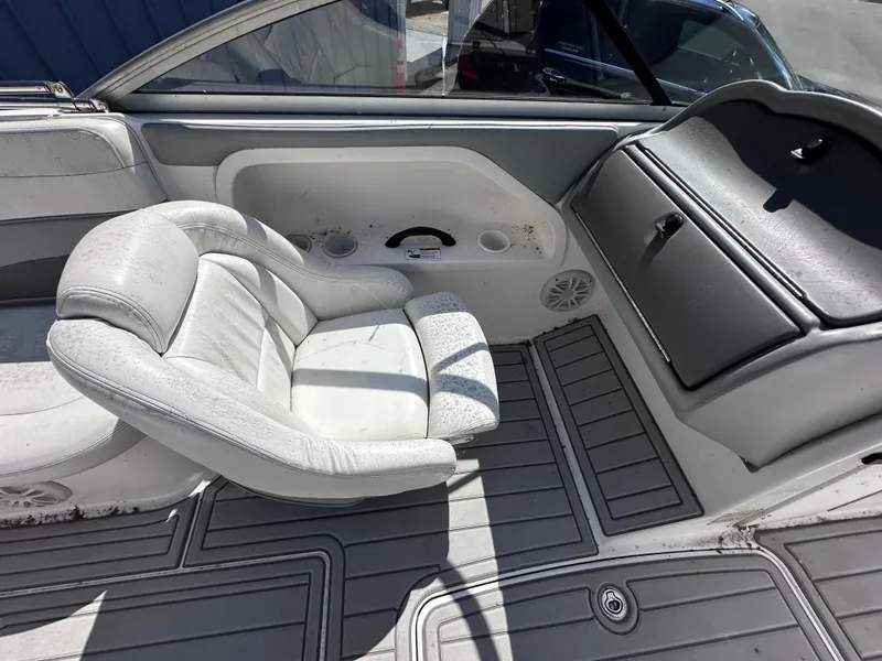 Slide: The Image of 2006 Yamaha Boats SX 230 interior with white seating and gray flooring. - 23