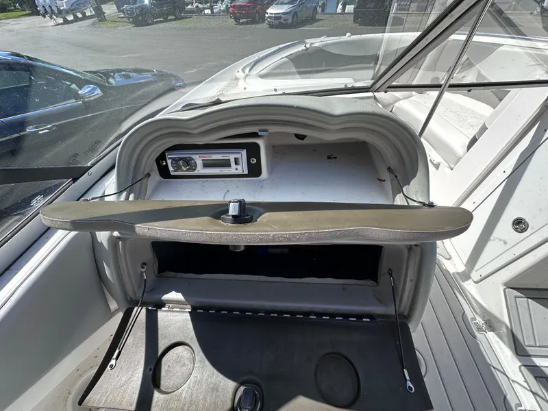 Slide: The Image of 2006 Yamaha Boats SX 230 dashboard with open glove compartment and stereo system. - 25